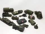 a lot of toy army vehicles and trucks on the table