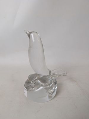 a glass bird that is sitting on top of a table