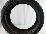 an image of a tire on a white surface with a red background