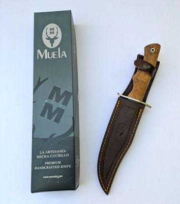 a knife that is laying on a table next to a box