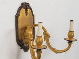 a wall mounted candle holder with two candles on it