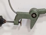 a green pipe cutter on a white surface