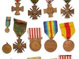 an assortment of medals and medals are displayed on a white surface