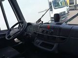 a truck that is driving down the street in front of a truck