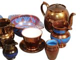 many different types of teapots and cups on the table