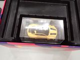 a yellow toy car in a black box