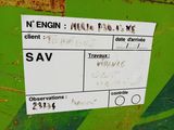 a sign on the side of a green dumpster