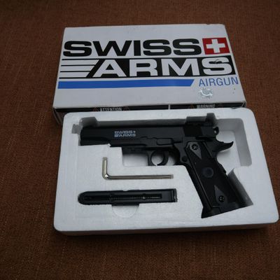 swiss arms airsofte gun in its box on a brown surface