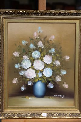 a painting of flowers in a blue vase on a easel