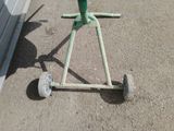 a small green machine that is sitting on the ground