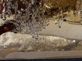 a close up of a glass vase with water coming out of it