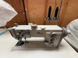 an image of a white sewing machine on a table