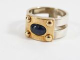 an image of a ring with a blue stone on it