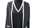 black cardigan with white trimmings and buttons on a mannequin mannequin mannequin mannequin mannequin mannequin manne
