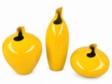 three yellow vases with a black top and a yellow vase with a black top