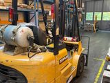 a forklift truck with a tank on it in a warehouse