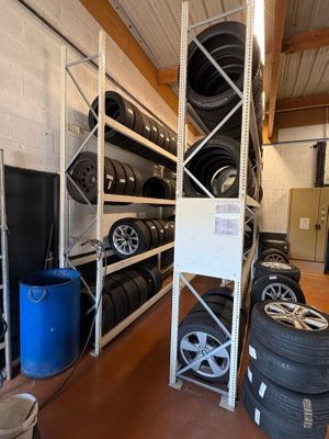 many tires stacked on the shelves in the garage