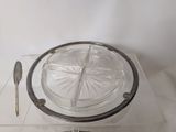 a glass plate with a spoon and a spoon rest on it