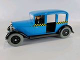 a blue toy car with a man sitting in the driver ' s seat