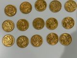 a close up of a person ' s hand holding a bunch of gold coins
