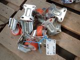 many pieces of metal and orange wheels on a pallet