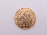 l'image d'une pièce d'or ornée d'un coq
