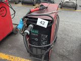 two welding machines that are sitting in the parking lot