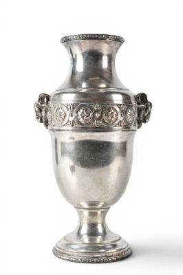 a silver vase that is sitting on a white surface