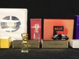 a lot of perfume bottles that are lined up on a table