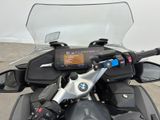 a close up of a motorcycle with a gps device on the handlebar