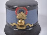 a black hat with a gold ball on it