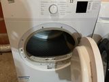 a washer and dryer sitting next to each other on the floor