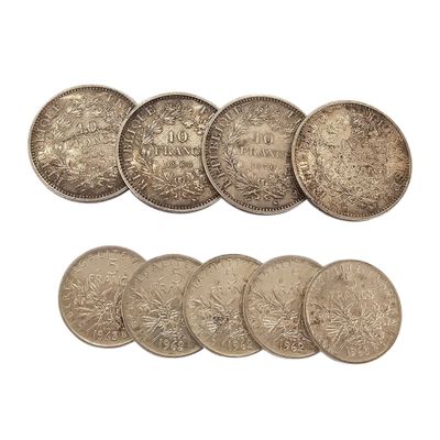 a bunch of coins sitting next to each other on top of a white surface