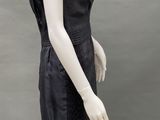 an image of a mannequin wearing a black dress and hat