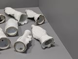 a lot of white vases that are on a table