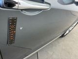 a close up of a car door handle with a sticker on it
