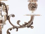 a silver candelab with a glass candle holder on it