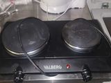 a stove top with two burners on it in a kitchen