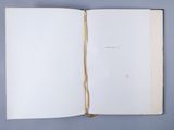 an open book on a blue surface with a white background