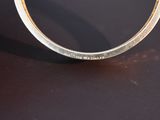 a close up of a silver ring with a diamond on it