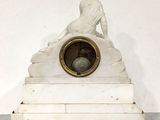 a statue of a woman sitting on top of a clock