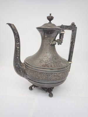 an antique silver tea pot with a handle on a white background