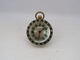 an image of a close up of a small clock on a table