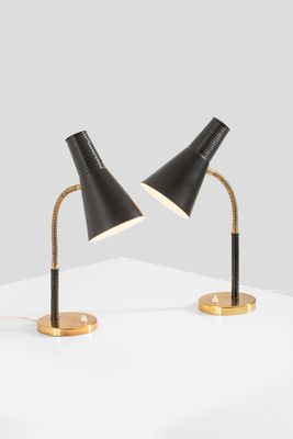 a pair of black lamps on a white surface