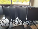 a lot of empty chairs in a room with a chalk board