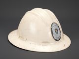 a white hard hat with a police badge on it