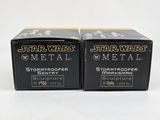 two boxes of star wars metal sit side by side on a white surface