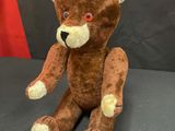 a brown teddy bear that is sitting on a table