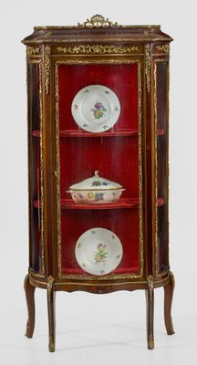 a red cabinet with plates on top of it