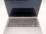a silver laptop computer sitting on top of a white table
